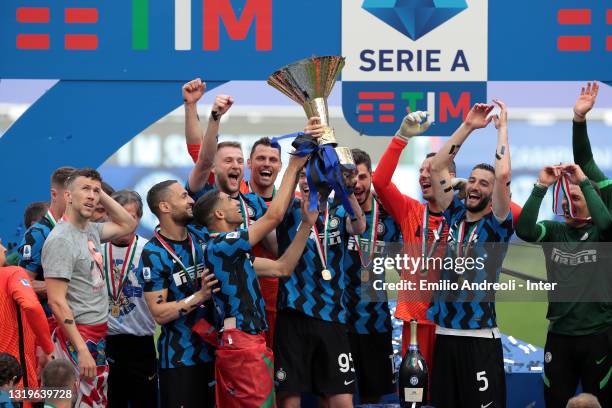 Players of FC Internazionale celebrate the trophy for the victory of nineteenth "scudetto" at the end of the last Serie A match between FC...