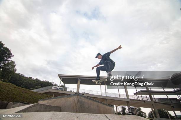 asian skateboarder in action jump in the air - extreme skateboarding stock pictures, royalty-free photos & images