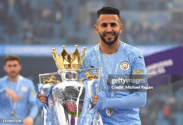 Riyad Mahrez of Manchester City celebrates with the Premier League Trophy as Manchester City are presented with the Trophy as they win the league...