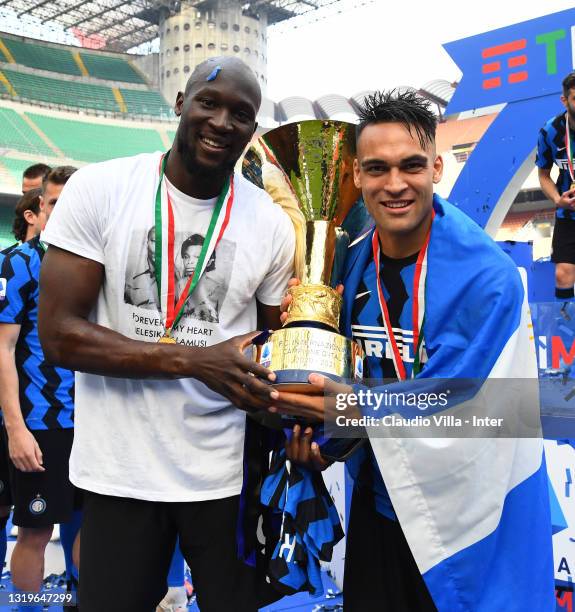 Romelu Lukaku and Lautaro Martinez of FC Internazionale pose with the trophy for the victory of "scudetto" at the end of the last Serie A match...