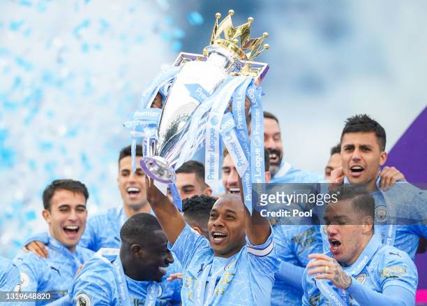 Fernandinho of Manchester City lifts the Premier League Trophy, as Manchester City are presented with the Trophy as they win the league following the...