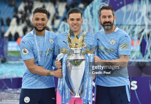 Zack Steffen, Ederson and Scott Carson of Manchester City celebrate with the Premier League Trophy as Manchester City are presented with the Trophy...