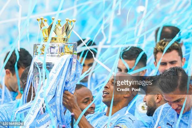 Fernandinho of Manchester City celebrates with the Premier League Trophy as Manchester City are presented with the Trophy as they win the league...