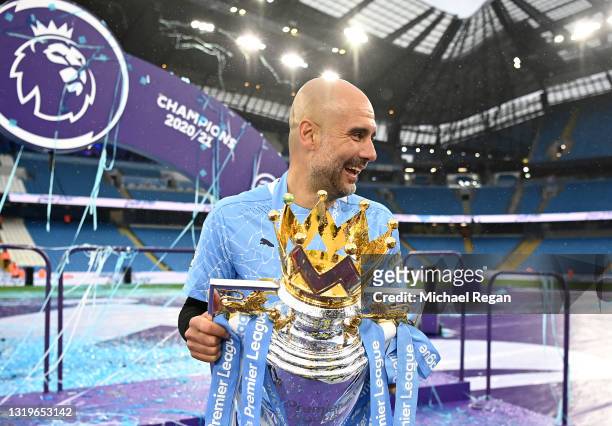 Pep Guardiola, Manager of Manchester City celebrates with the Premier League Trophy as Manchester City are presented with the Trophy as they win the...