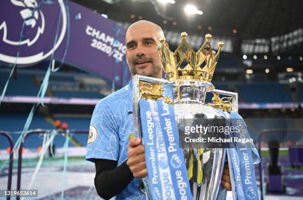 Pep Guardiola, Manager of Manchester City celebrates with the Premier League Trophy as Manchester City are presented with the Trophy as they win the...