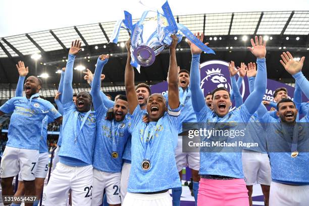 Fernandinho of Manchester City lifts the Premier League Trophy, as Manchester City are presented with the Trophy as they win the league following the...