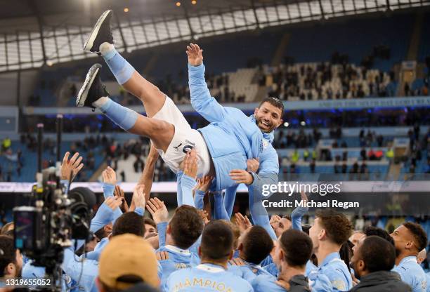 Sergio Aguero of Manchester City is thrown into the air by his teammates after playing his last game for Manchester City following the Premier League...