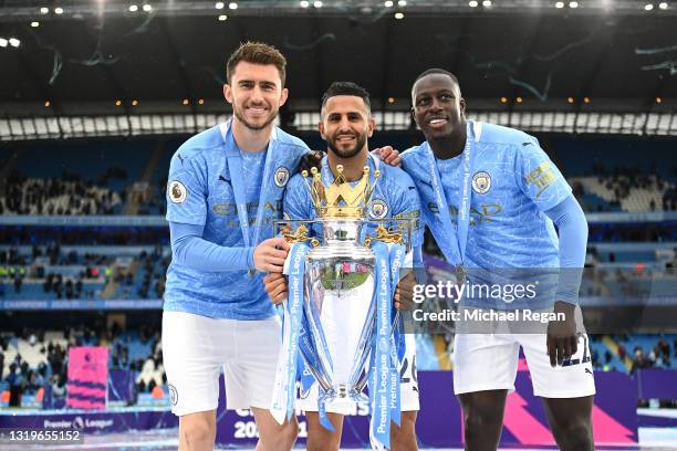 Aymeric Laporte, Riyad Mahrez, Benjamin Mendy celebrates with the Premier League Trophy as Manchester City are presented with the Trophy as they win...