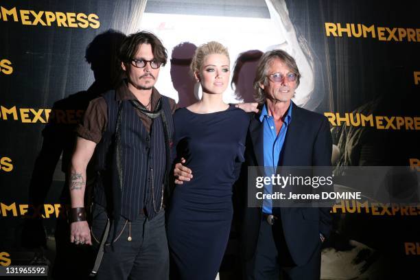 Johnny Depp, Amber Heard and Bruce Robinson attend the 'Rhum Express' Paris Premiere at Cinema Gaumont Marignan on November 8, 2011 in Paris, France.