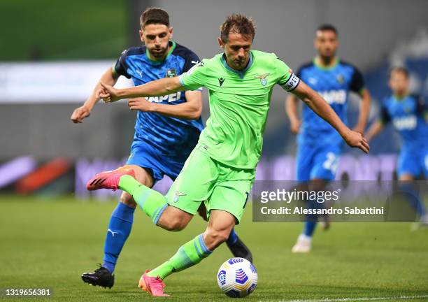 Senad Lulic of S.S. Lazio battles for possession with Domenico Berardi of U.S. Sassuolo Calcio during the Serie A match between US Sassuolo and SS...