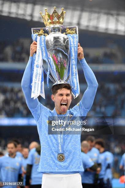 John Stones of Manchester City celebrates with the Premier League Trophy as Manchester City are presented with the Trophy as they win the league...