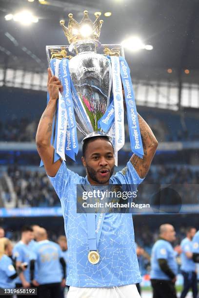 Raheem Sterling of Manchester City celebrates with the Premier League Trophy as Manchester City are presented with the Trophy as they win the league...