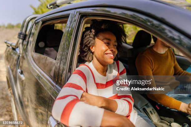 young couple on a road trip - man and woman and car stock pictures, royalty-free photos & images