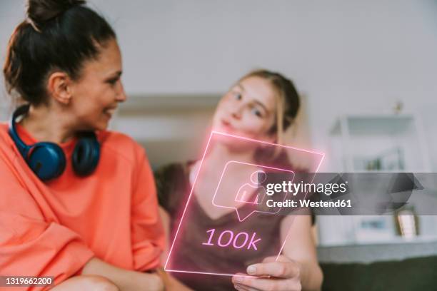 female influencers discussing over 100k followers on social media at home - following stock pictures, royalty-free photos & images