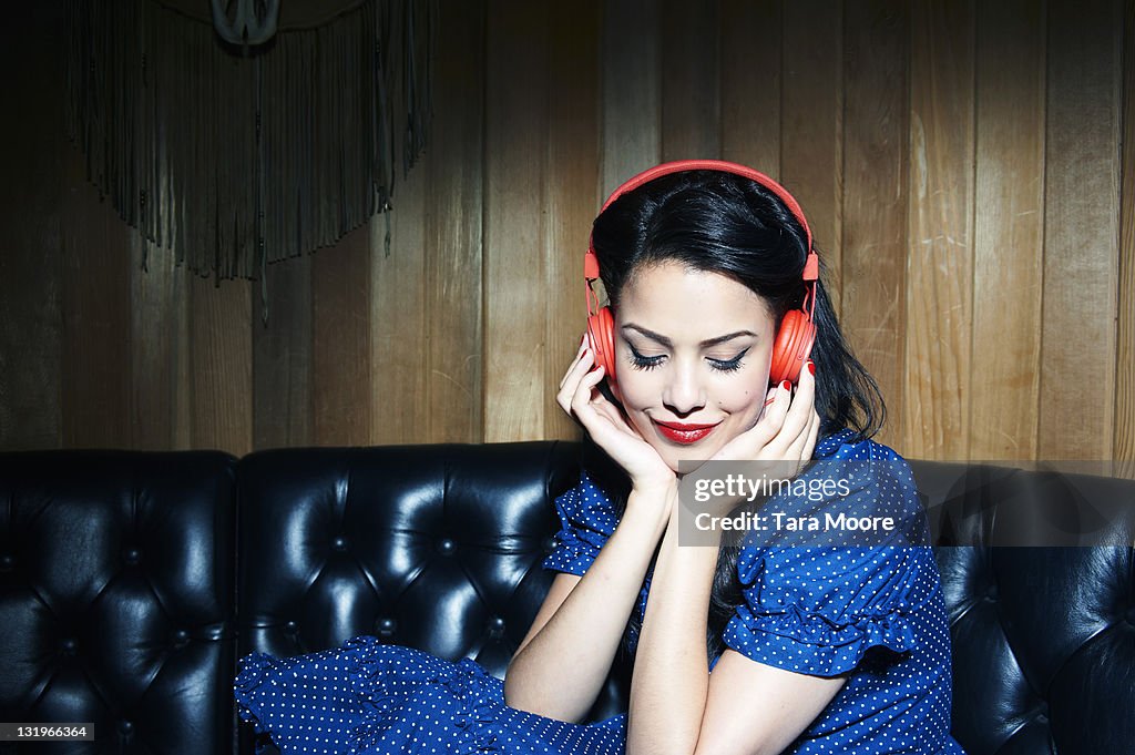 Young woman listening to music wearing headphones