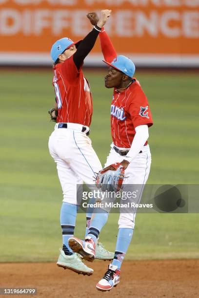 Miguel Rojas and Jazz Chisholm Jr. #2 of the Miami Marlins celebrate after defeating the New York Mets 5-1 at loanDepot park on May 23, 2021 in...