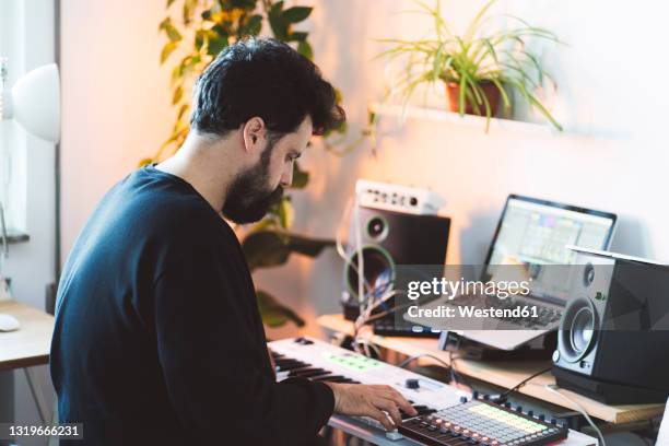 male music composer using piano in studio - electric piano stock pictures, royalty-free photos & images