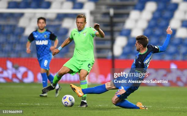 Georgios Kyriakopoulos of Sassuolo tackles Lucas Leiva of SS Lazio during the Serie A match between US Sassuolo and SS Lazio at Mapei Stadium -...