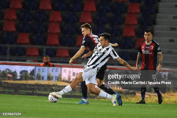 Paulo Dybala of Juventus competes the ball with Jerdy Schouten of Bologna FC during the Serie A match between Bologna FC and Juventus at Stadio...
