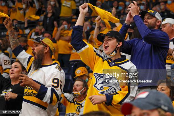 Fans of the Nashville Predators cheer after a goal against the Carolina Hurricanes during the second period in Game Four of the First Round of the...