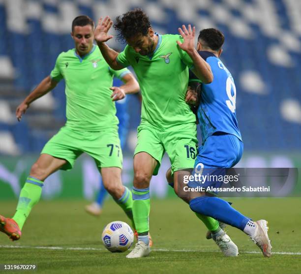 Marco Parolo of SS Lazio tackles Francesco Caputo of Sassuolo to give away a penalty leading to Sassuolo's second goal during the Serie A match...