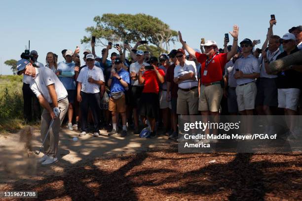 Kevin Streelman of the United States plays a third shot on the seventh hole as a gallery of fans look on during the final round of the 2021 PGA...