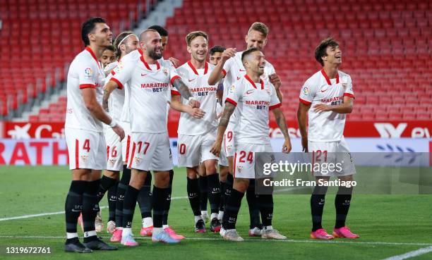 Alejandro Gomez of Sevilla FC celebrates after scoring their team's first goal with Oliver Torres and Luuk de Jong during the La Liga Santander match...