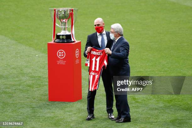 Luis Rubiales, President of Spanish Federation of Football, receives an official T-shirt from Enrique Cerezo, President of Atletico de Madrid, during...