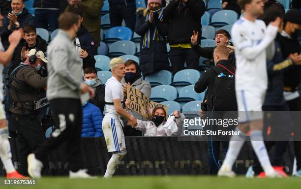 Happy little girl in the crowd smiles after Ezgjan Alioski of Leeds gives her his playing shirt after the Premier League match between Leeds United...