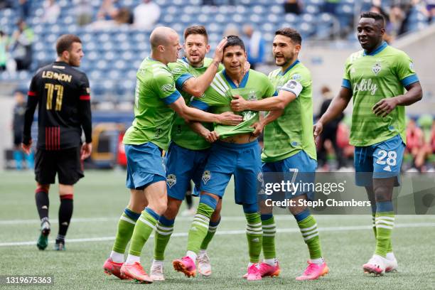 Raul Ruidiaz of Seattle Sounders celebrates his goal with teammates in the sixth minute against the Atlanta United at Lumen Field on May 23, 2021 in...