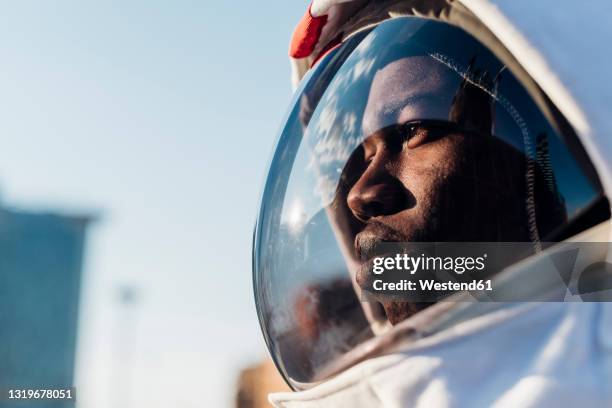 thoughtful astronaut looking away - astronaut bildbanksfoton och bilder