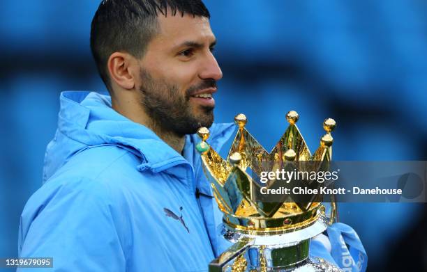 Sergio Aguero of Manchester City holds the Premier League trophy after the Premier League match between Manchester City and Everton at Etihad Stadium...