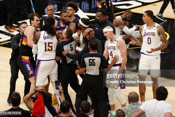 Montrezl Harrell, Alex Caruso and Wesley Matthews of the Los Angeles Lakers come together with Dario Saric, Cameron Payne and Mikal Bridges of the...