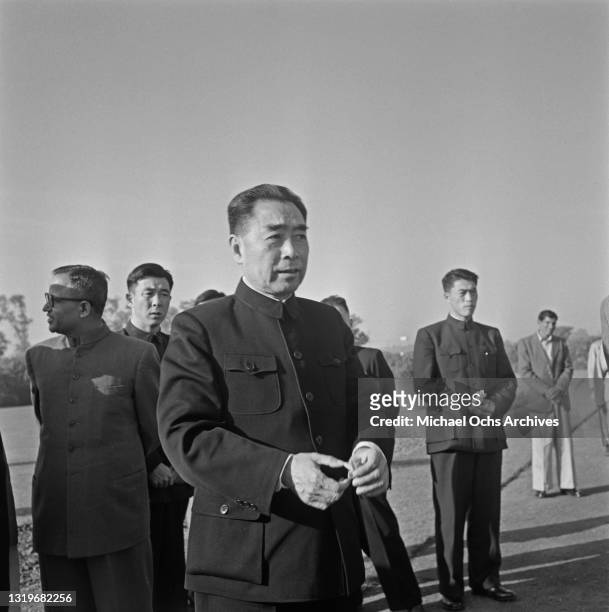 Premier of the People's Republic of China Zhou Enlai , wearing a Zhongshan suit with unspecified civil servants, location unspecified, during a visit...