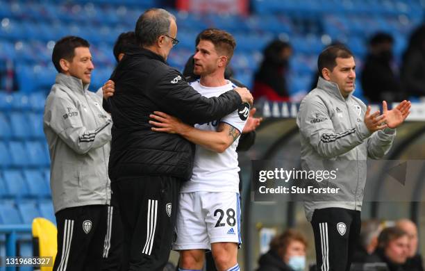 Gaetano Berardi of Leeds is embraced by manager Marcelo Bielsa after he leaves the pitch after his last match for Leeds during the Premier League...