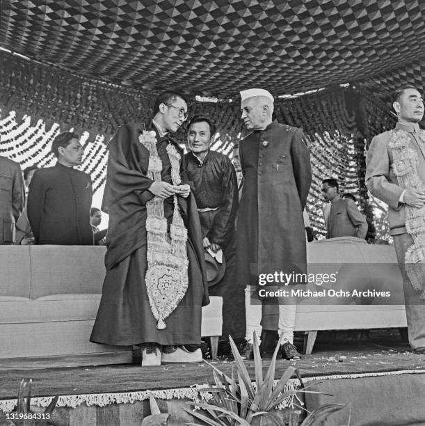 The Dalai Lama speaking with an unspecified man alongside Indian independence activist and politician Jawaharlal Nehru , Prime Minister of India,...