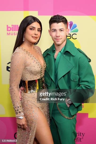 Priyanka Chopra Jonas and Nick Jonas pose backstage for the 2021 Billboard Music Awards, broadcast on May 23, 2021 at Microsoft Theater in Los...