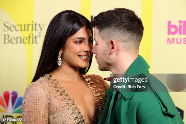 Priyanka Chopra Jonas and Nick Jonas pose backstage for the 2021 Billboard Music Awards, broadcast on May 23, 2021 at Microsoft Theater in Los...