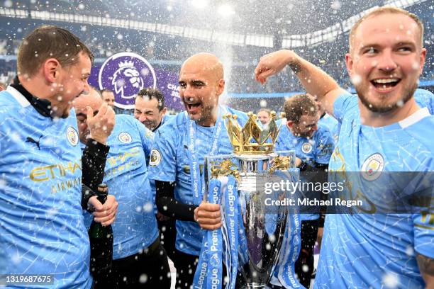 Pep Guardiola, Manager of Manchester City celebrates with the Premier League Trophy as Manchester City are presented with the Trophy as they win the...