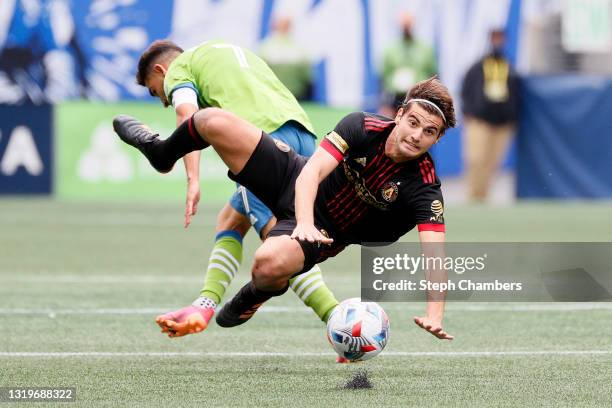 Santiago Sosa of Atlanta United and Cristian Roldan of Seattle Sounders collide during the second half at Lumen Field on May 23, 2021 in Seattle,...