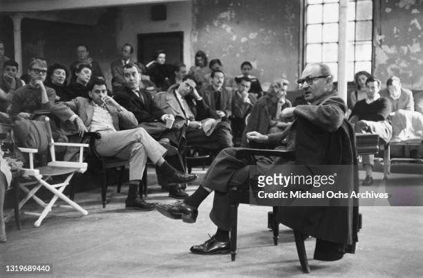 Polish-born American actor, director, and drama teacher Lee Strasberg teaching with students seated in the lecture hall in the background, at the...