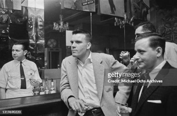 Unspecified guests watch an unseen performer from the bar at an unspecified nightclub in New York City, New York, circa 1955.