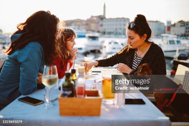 all female family at the pet friendly restaurant - croatia food stock pictures, royalty-free photos & images