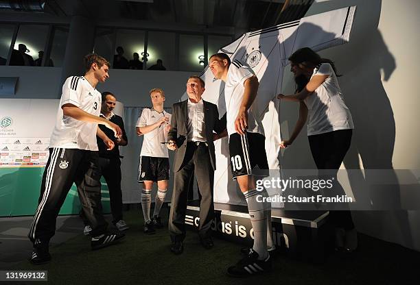 Players pose with the new football kit during the German national team Euro 2012 jersey launch at teh Mercedes Benz center on November 9, 2011 in...