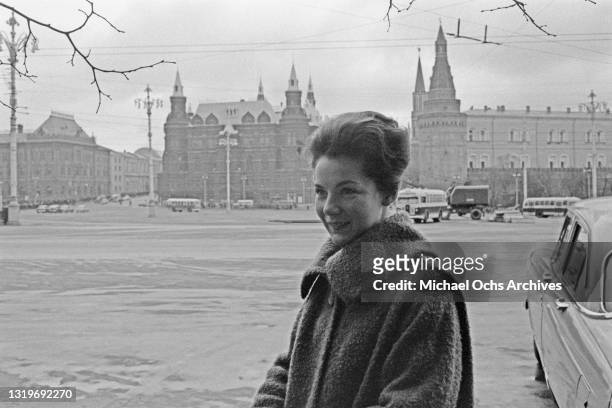 An unspecified woman, wearing a warm coat, in Red Square with the State Historical Museum in the background, in Moscow, Russia, Soviet Union,...