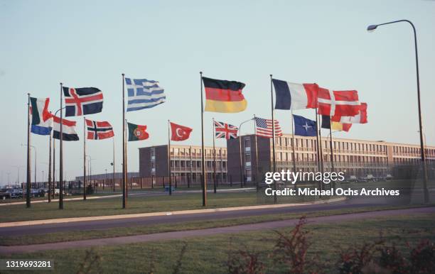 Flags of the member states flying before the NATO headquarters Brussels, Belgium, circa 1970. Among the flags of the North Atlantic Treaty...