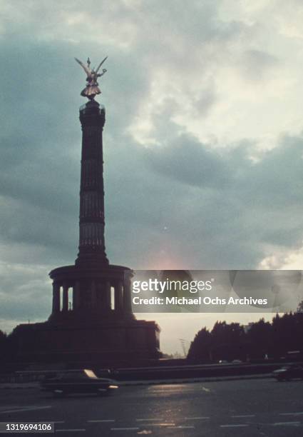The Berlin Victory Column , almost in silhouette, as traffic passes along a road in West Berlin, Federal Republic of Germany, circa 1965. Inaugurated...