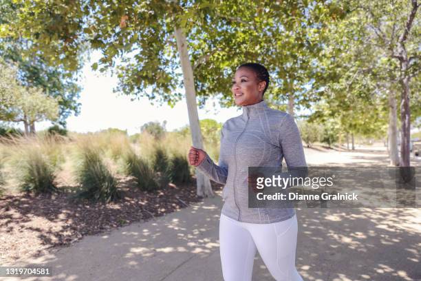 attractive black woman exercising in nature - speed walking stock pictures, royalty-free photos & images