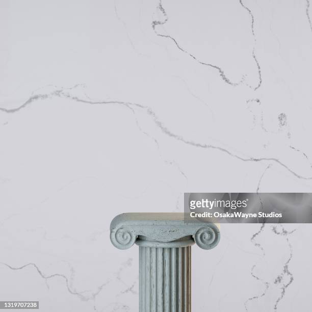 ancient decorative column against light marble stone background. - ancient greece stock pictures, royalty-free photos & images