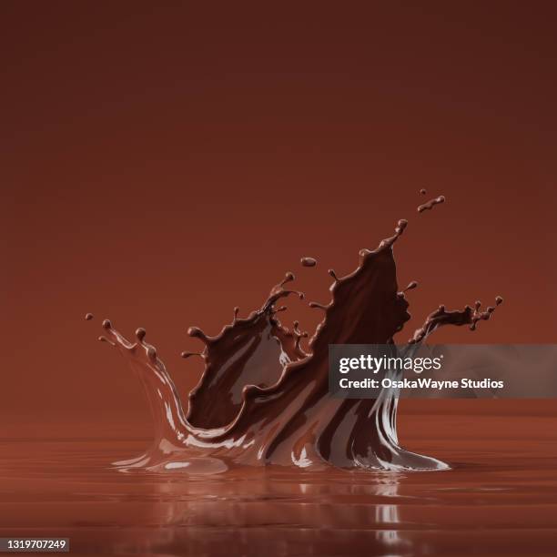 low angle view of melted brown liquid crown splash. - chocolate stockfoto's en -beelden